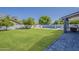 Expansive green backyard features a pool, patio, grill, and privacy fence, offering a private retreat at 3252 E Lexington Ave, Gilbert, AZ 85234