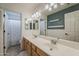 This bathroom features double sinks, modern lighting, and a shower-tub combo, blending style and functionality at 3252 E Lexington Ave, Gilbert, AZ 85234