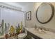 Bathroom features a stylish marble countertop, designer mirror, and decorative cactus shower curtain at 3252 E Lexington Ave, Gilbert, AZ 85234