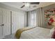 This inviting bedroom has a queen bed with soft white bedding and a bright throw and closet with sliding doors at 3252 E Lexington Ave, Gilbert, AZ 85234
