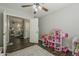 Cute bedroom with dark wood look floors, walk-in closet and a playful dollhouse at 3252 E Lexington Ave, Gilbert, AZ 85234
