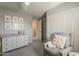 Charming Bedroom with gray walls, a plush glider, and a white dresser, creating a cozy and stylish space at 3252 E Lexington Ave, Gilbert, AZ 85234