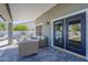 Relaxing covered patio with comfortable seating and double doors leading to a refreshing pool at 3252 E Lexington Ave, Gilbert, AZ 85234