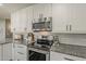 This modern kitchen features white cabinets, granite countertops, and stainless appliances at 3252 E Lexington Ave, Gilbert, AZ 85234