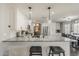 Open-concept kitchen with an island, white cabinets, and stainless steel appliances at 3252 E Lexington Ave, Gilbert, AZ 85234