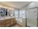 Main bathroom featuring double sinks, a soaking tub, and a separate shower at 3252 E Lexington Ave, Gilbert, AZ 85234