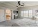 Main bedroom with TV, arched doorway to bathroom, and a ceiling fan at 3252 E Lexington Ave, Gilbert, AZ 85234