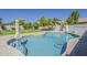 Sparkling pool with a stone surround, green lawn, and mature trees creates a serene outdoor oasis at 3252 E Lexington Ave, Gilbert, AZ 85234