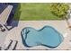Aerial view of a uniquely shaped pool complemented by deck chairs for relaxation at 3252 E Lexington Ave, Gilbert, AZ 85234