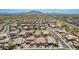 A sprawling community aerial view with many homes under a blue sky, with mountains in the distance at 3269 E Ironside Ln, Gilbert, AZ 85298