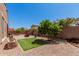 Serene backyard with lush landscaping, artificial turf, gravel, seating, and a well-maintained perimeter fence at 3269 E Ironside Ln, Gilbert, AZ 85298