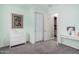 Bedroom featuring neutral colored walls, white trim, carpeted floors, and a closet with sliding doors at 3269 E Ironside Ln, Gilbert, AZ 85298