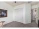 Bedroom featuring light colored walls, white trim, carpeted floors, and a closet with sliding doors at 3269 E Ironside Ln, Gilbert, AZ 85298