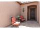 Inviting courtyard featuring comfortable chairs, a decorative table, and a stylish entry door at 3269 E Ironside Ln, Gilbert, AZ 85298