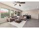 Spacious living room with a sectional sofa, large windows, and an adjacent dining area at 3269 E Ironside Ln, Gilbert, AZ 85298