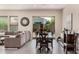 Open-concept living and dining area featuring neutral tones, tile floors, and sliding doors to the backyard at 3269 E Ironside Ln, Gilbert, AZ 85298