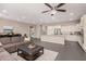 Open-concept living space with tile flooring, a large sofa, and an eat-in kitchen area at 3269 E Ironside Ln, Gilbert, AZ 85298