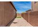 Side yard with well-maintained gravel, artificial turf, stepping stones, and a sturdy perimeter wall at 3269 E Ironside Ln, Gilbert, AZ 85298