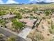 Expansive desert home with 3-car garage, fenced yard, and lush landscaping viewed from above at 3816 E El Sendero Rd, Cave Creek, AZ 85331