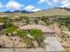 Stunning aerial view of a desert home highlighting its tile roof and beautiful mountain views at 3816 E El Sendero Rd, Cave Creek, AZ 85331