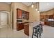 Elegant bar area features wood cabinetry, granite countertops, and modern pendant lighting, perfect for entertaining at 3816 E El Sendero Rd, Cave Creek, AZ 85331