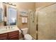 Well-lit bathroom featuring a glass-enclosed shower and vanity with marble countertop and dark-stained cabinets at 3816 E El Sendero Rd, Cave Creek, AZ 85331