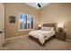 Cozy bedroom with a queen-sized bed, neutral walls, carpet, and window with shutters, creating a relaxing atmosphere at 3816 E El Sendero Rd, Cave Creek, AZ 85331