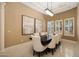 Formal dining room showcasing a dark wood table, neutral upholstered chairs, and ample natural light at 3816 E El Sendero Rd, Cave Creek, AZ 85331