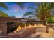 Inviting outdoor fire pit with elegant glass surround, perfect for cozy evenings under the palm trees at 3816 E El Sendero Rd, Cave Creek, AZ 85331