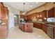 Spacious kitchen with custom wood cabinets, granite countertops, stainless appliances, and tile flooring at 3816 E El Sendero Rd, Cave Creek, AZ 85331