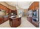 Gourmet kitchen featuring custom cabinetry, stainless steel appliances, granite counters, and tiled floors at 3816 E El Sendero Rd, Cave Creek, AZ 85331