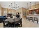 Spacious living area with an adjacent fireplace, breakfast bar, and open floor plan design at 3816 E El Sendero Rd, Cave Creek, AZ 85331