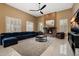 Spacious living room with a fireplace and large windows offering ample natural light and modern ceiling fan at 3816 E El Sendero Rd, Cave Creek, AZ 85331