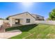 Backyard featuring a well-maintained lawn, a covered patio, and a block fence at 3994 E Maplewood St, Gilbert, AZ 85297