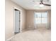 Comfortable bedroom with neutral carpet, a ceiling fan, window with blinds, and light-colored walls at 3994 E Maplewood St, Gilbert, AZ 85297