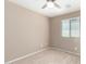 Neutral bedroom featuring a ceiling fan, carpeted floors, and bright window at 3994 E Maplewood St, Gilbert, AZ 85297
