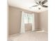 Light-filled bedroom with a ceiling fan, carpet flooring, a window with blinds, and neutral-colored walls at 3994 E Maplewood St, Gilbert, AZ 85297
