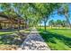 A shaded walkway leads through the community park with picnic pavilion and mature trees at 3994 E Maplewood St, Gilbert, AZ 85297