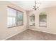 Dining room featuring tiled floors, three arched windows, modern light fixture, and neutral wall color at 3994 E Maplewood St, Gilbert, AZ 85297