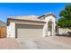 Charming single-story home with a two-car garage, desert landscaping, and a tile roof under a clear blue sky at 3994 E Maplewood St, Gilbert, AZ 85297