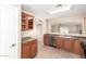 Well-lit kitchen featuring wood cabinets, stainless steel appliances, and tile flooring at 3994 E Maplewood St, Gilbert, AZ 85297
