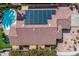 Aerial view of the property showcasing the solar panels on the roof and a private backyard pool and patio area at 4061 W Tonopah Dr, Glendale, AZ 85308