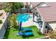 Aerial view of backyard featuring a refreshing pool, lounge area, and lush landscaping at 4061 W Tonopah Dr, Glendale, AZ 85308