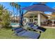 Relaxing backyard with lounge chairs, a shady umbrella, and a sparkling pool at 4061 W Tonopah Dr, Glendale, AZ 85308