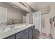 Bathroom with double vanity, tiled backsplash, framed mirror, and shower-tub combo at 4061 W Tonopah Dr, Glendale, AZ 85308