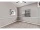 Cozy carpeted bedroom with natural light, neutral walls, crown molding, and a ceiling fan at 4061 W Tonopah Dr, Glendale, AZ 85308