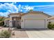 One-story home with a 2-car garage, desert landscaping, and a tile roof at 4061 W Tonopah Dr, Glendale, AZ 85308