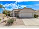 Charming one-story house with a two car garage and desert landscaping at 4061 W Tonopah Dr, Glendale, AZ 85308