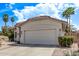 A well-maintained home exterior with a garage, desert landscaping, and a tile roof at 4061 W Tonopah Dr, Glendale, AZ 85308
