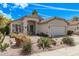 Exterior of home featuring desert landscaping, tile roof, covered porch and two car garage at 4061 W Tonopah Dr, Glendale, AZ 85308